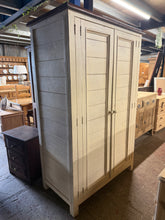 Load image into Gallery viewer, This solid pine two-tone wardrobe combines practical storage with timeless design. Well-maintained and structurally sound, it features a full-length hanging rail, short rail, one drawer, and two shelves—ideal for maximising bedroom or dressing room space. Minor cosmetic marks reflect honest pre-loved character. One door catch may need adjustment. A versatile piece perfect for those seeking quality furniture with authentic vintage appeal.

Delivery Available

Overall Dimensions

116cm wide x 61cm deep x 180c
