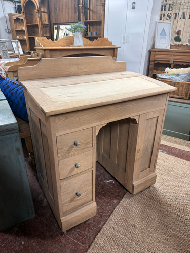 Discover the timeless appeal of authentic wood with this beautifully stripped oak desk. Revealing the grain's natural character, it's ready for your personal finishing touch—a protective wax coat will enhance its rustic charm. Cleverly designed with a lift-top storage compartment, a single cupboard, and three compact drawers, this piece combines classic aesthetics with practical organisation.

Overall Dimensions

81cm wide x 49cm deep x 94cm high

DELIVERY AVAILABLE      

For our other items see our websit