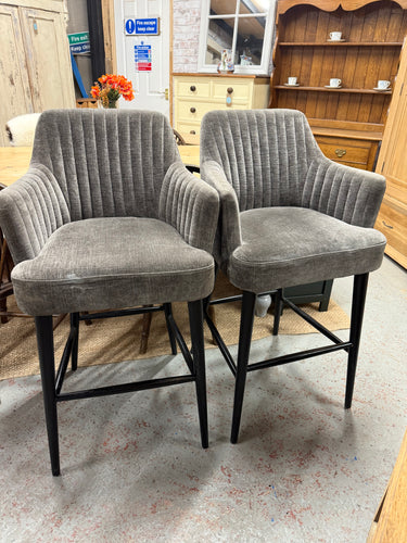 These two stylish dark grey bar stools are sturdy and in good shape. Although they show some signs of use with minor marks, nothing is too noticeable. A thorough steam clean will easily refresh them and remove any blemishes.

Delivery Available

Overall Dimensions

approx: 59cm wide x 48cm deep x 109cm high

