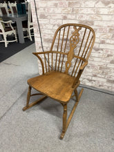 Load image into Gallery viewer, A charming Windsor-style rocker crafted from elm and beech, this piece combines classic design with authentic character. While showing its years through natural wear and patina, the chair remains structurally solid and fully functional. Minor age-related marks are visible—refer to photos for details—but nothing detracts from its appeal. Ideal for adding warmth to a living room, bedroom, or cosy reading corner, this vintage find brings timeless elegance to any space.

Delivery Available

Overall Dimensions


