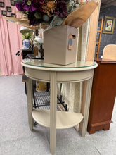 Load image into Gallery viewer, A beautifully hand-painted cream demi lune hall table with a charming distressed finish. Structurally sound and in excellent condition, this piece features a practical removable glass top. Perfect for adding vintage character to your hallway or living space.

Delivery Available

Overall Dimensions

65cm wide x 33cm deep x 76cm high
