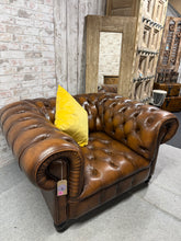 Load image into Gallery viewer, A classic brown leather Chesterfield club armchair with authentic character. This well-built piece showcases the timeless appeal of traditional design, featuring the signature deep button detailing and rolled arms. While showing honest signs of use with minor surface marks, primarily on the left seat area, the chair remains structurally sound and ready for years of comfortable seating. An excellent choice for creating a sophisticated study or lounge setting.

Delivery Available

Overall Dimensions

approx :
