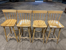 Load image into Gallery viewer, A practical set of four pine stools ideal for kitchen islands or breakfast bars. Each stool shows honest signs of use with minor surface marks, yet remains sturdy and fully functional. The natural pine construction offers a warm, understated aesthetic that complements various kitchen styles.

Delivery Available

Overall Dimensions

40cm wide x 40.5cm deep x 100cm high
