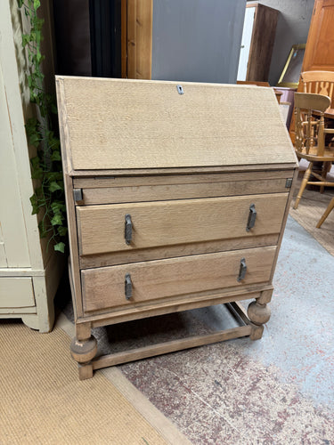 Discover the potential of this authentic oak bureau, ready for your personal touch. Featuring a practical pull-down writing surface and two generously sized dovetail-jointed drawers, it offers both functionality and character. With its stripped-back finish, a protective wax coating will enhance its natural beauty and ensure lasting durability. Perfect for those who appreciate quality craftsmanship and timeless design.

Delivery Available

Overall Dimensions

72cm wide x 41cm deep x 95cm high    &n