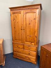 Load image into Gallery viewer, Built from solid pine with genuine structural integrity, this wardrobe delivers substantial storage capacity through one hanging rail and four dovetail-jointed drawers—two compact and two full-length. The piece shows honest wear with surface marks and paint marks. Splits into two sections for practical handling and installation.&nbsp;

Delivery Available

Overall Dimensions

100cm wide x 59cm deep x 190cm high

