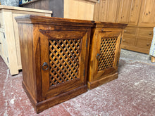 Load image into Gallery viewer, A handsome pair of sheesham wood bedside tables, built to last. Each features a single cupboard with internal shelf storage—ideal for keeping essentials within arm's reach. Both are structurally sound and in good working order. One unit has a missing door latch, though this doesn't impact functionality. As pre-loved pieces, they show gentle signs of use and minor surface marks consistent with their age. Perfect for adding warmth and character to any bedroom.

Delivery Available

Overall Dimensions

50cm wid
