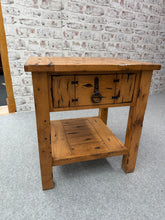 Load image into Gallery viewer, This charming teak side table is surprisingly solid and remains in excellent shape. It’s pre-loved with a few small marks, but nothing serious. Equipped with one drawer and a lower shelf, it offers practical storage. Made by the Kingdom Teak brand, it’s a lovely addition to any room.

Overall Dimensions

66cm wide x 58cm deep x 72cm high

DELIVERY AVAILABLE      

For our other items see our website https://fossewayfurniture.co.uk

collection from our shop at cv36, our collection zone at bs36 or otherwise d

