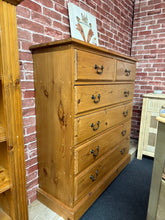Load image into Gallery viewer, A charming narrow pine chest of drawers, expertly crafted with solid construction and dovetail jointed drawers. This piece combines functionality with space-saving design—ideal for bedrooms, hallways, or compact living areas. Features 2 short drawers positioned above 4 spacious long drawers, offering versatile storage solutions. In excellent condition with the character and durability of quality pine furniture.

Delivery Available

Overall Dimensions

102cm wide x 35cm deep x 109cm high\
