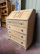 Load image into Gallery viewer, A characterful stripped oak bureau with authentic patina and honest wear. Features a pull-down writing desk and four generous drawers offering practical storage for home offices. The natural wood finish showcases the oak's grain and warmth, though a protective wax coat is recommended. Minor marks and edge damage add to its vintage charm without compromising functionality. An ideal choice for those seeking genuine period furniture with character and utility.

Delivery Available

Overall Dimensions

76cm wide
