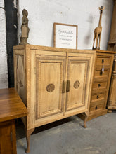 Load image into Gallery viewer, This striking stripped oak cupboard showcases the wood's natural beauty and character. It has some marks that enhance its rustic charm, it's ready for finishing with wax or oil to suit your décor. The generous double-door design houses a single shelf, offering practical storage with undeniable style. A versatile statement piece for any room. Please note it does have some marks to the top but nothing that effects its use.

Delivery Available

Overall Dimensions

82cm wide x 49cm deep x 102cm high
