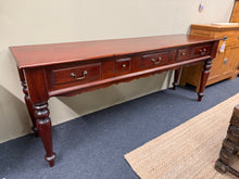 Load image into Gallery viewer, This spacious mahogany hall table combines solid construction with practical design. Structurally sound and in good overall condition, it bears light cosmetic marks that respond readily to polishing. Storage comprises three short drawers and two compact ones, ideal for organising hallway clutter. A dependable, hardworking piece that delivers both form and function.

Delivery Available

Overall Dimensions

190cm wide x 50cm deep x 75.5cm high

