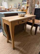 Load image into Gallery viewer, Beautifully crafted oak console table with solid construction and authentic character. Features two dovetail-jointed drawers for practical storage. This pre-loved piece shows gentle wear consistent with quality furniture, with minor marks that don't detract from its appearance. Ideal for entryways, living rooms, or hallway displays where you need both style and function.

Delivery Available

Overall Dimensions

100cm wide x 41cm deep x 76.5cm high


