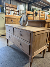 Load image into Gallery viewer, This elegant low mahogany chest of drawers showcases beautiful natural wood grain after being carefully stripped back. Featuring two short dovetail-jointed drawers above one longer drawer, it combines classic craftsmanship with practical storage. The piece is structurally sound and in good overall condition. A protective wax finish is recommended to enhance and preserve the wood's natural beauty and durability.

Delivery Available

Overall Dimensions

99cm wide x 44.5cm deep x 62.5cm high

