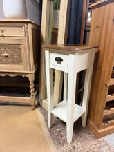 Load image into Gallery viewer, A classic two-tone wooden plant stand that combines style with practical storage. This piece features a spacious top surface perfect for displaying your favourite plants, a convenient drawer for storing accessories, and a lower shelf for additional display or storage. Despite a minor surface mark, the stand remains structurally sound and in good condition, ready to become a functional focal point in your home or garden space.

Delivery Available

Overall Dimensions

30cm wide x 30cm deep x 78cm high

