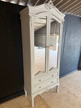 Load image into Gallery viewer, A versatile grey armoire combining practical storage with timeless style. Features one shelf and two spacious drawers, ideal for organising bedroom essentials. Shows gentle signs of use but nothing major. A dependable addition to any bedroom layout.

Delivery Available

Overall Dimensions

77.5cm wide x 36cm deep x 192cm high

