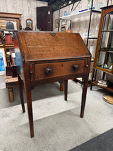 Load image into Gallery viewer, A characterful oak bureau combining timeless design with practical functionality. This well-preserved piece features a pull-down writing desk with multiple drawers and a substantial dovetail-jointed drawer, offering generous storage for documents, stationery, and personal items. Showing authentic signs of age and use, it retains its structural integrity and solid craftsmanship. An ideal addition to period homes, studies, or anyone seeking quality vintage furniture with genuine character and storage solution
