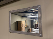 Load image into Gallery viewer, A striking silver-framed mirror featuring elegant geometric detailing at each corner. The frame is in excellent structural condition and makes a refined addition to any room without overwhelming the space. Perfect for those seeking understated sophistication with visual interest.

Delivery Available

Overall Dimensions

104cm x 73cm&nbsp;&nbsp;

