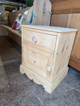 Load image into Gallery viewer, This charming pine bedside has been fully stripped to reveal its natural beauty and may benefit from a wax finish to keep it protected. It includes one drawer with dovetail joints above a single cupboard, combining style and practicality.

Overall Dimensions

45cm wide x 40cm deep x 58cm high

DELIVERY AVAILABLE      

For our other items see our website https://fossewayfurniture.co.uk

collection from our shop at cv36, our collection zone at bs36 or otherwise delivery is available

