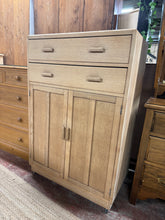 Load image into Gallery viewer, Authentic stripped oak cupboard revealing beautiful natural grain and patina. Features two dovetail-jointed drawers and three spacious shelves, offering generous storage for any room. The bare wood finish showcases the timber's character—a light wax application will enhance protection and lustre. A versatile piece that complements both traditional and contemporary interiors.

Delivery Available

Overall Dimensions

84cm wide x 47cm deep x 131cm high
