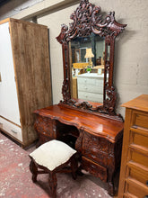 Load image into Gallery viewer, A characterful Continental Carved Dressing Table that combines practicality with french style charm. Well-maintained and ready for use, this piece showcases intricate carved detailing that commands attention in any bedroom setting. The robust construction features six dovetail-jointed drawers offering generous storage space, whilst the removable mirror simplifies transportation and repositioning. Expected wear reflects its years of use, yet nothing detracts from its appeal as a functional and decorative bed

