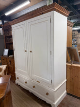 Load image into Gallery viewer, A timeless solid pine double wardrobe built to last. This piece combines practical storage with classic craftsmanship—featuring a spacious hanging rail and two dovetail-jointed drawers for organized dressing. Solid construction with authentic character marks that reflect its use. Designed for flexibility: the entire wardrobe disassembles for convenient moving and repositioning. Perfect for bedrooms seeking both functionality and enduring style.

Delivery Available

Overall Dimensions

163cm wide x 60cm deep
