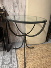 Load image into Gallery viewer, An elegant wrought iron side table featuring a tempered glass top that's easy to clean and maintain. The robust iron frame delivers lasting strength while its timeless design complements both traditional and contemporary interiors. Authentic surface patina enhances its vintage appeal. Ideal for beside sofas, armchairs, or as a display surface for lamps and accessories.

Delivery Available

Overall Dimensions

23.5cm diameter x 76cm high

