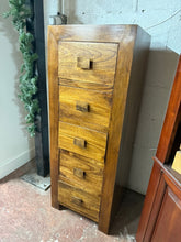 Load image into Gallery viewer, Discover the timeless beauty of a hardwood tallboy. With its sturdy structure and good condition, this piece is sure to impress. Adorned with 5 drawers, it provides plenty of storage options for all your belongings.

Overall Dimensions

46cm wide x 40cm deep x 123cm high

DELIVERY AVAILABLE      

For our other items see our website https://fossewayfurniture.co.uk

collection from our shop at cv36, our collection zone at bs36 or otherwise delivery is available


