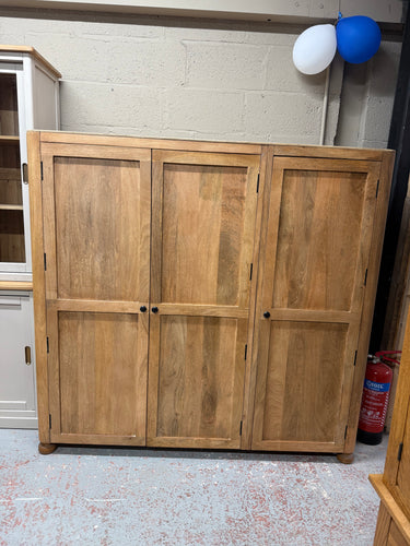 This beautiful triple child's wardrobe, crafted from mango wood, is sturdy and well-maintained. It features one double cupboard and one single cupboard, each equipped with a hanging rail inside. The top is made of plywood, but with a bit of wax, it will blend in nicely.

Overall Dimensions

156cm wide x 63cm deep x 150cm high

DELIVERY AVAILABLE      

For our other items see our website https://fossewayfurniture.co.uk

collection from our shop at cv36, our collection zone at bs36 or otherwise delivery is a