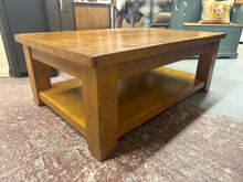 Load image into Gallery viewer, This sturdy solid wood coffee table is well-built and remains in great shape overall. It shows some light signs of use, but nothing significant. Plus, it features a handy lower shelf for extra storage.

Overall Dimensions

120cm wide x 80cm deep x 46cm high

DELIVERY AVAILABLE      

For our other items see our website https://fossewayfurniture.co.uk

collection from our shop at cv36, our collection zone at bs36 or otherwise delivery is available

