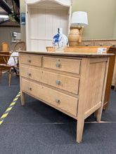 Load image into Gallery viewer, An elegant oak chest of drawers in sound, structurally solid condition. Recently stripped back to natural wood, revealing beautiful grain detail—it may benefit from wax finishing for added protection and lustre. Features two short dovetail-jointed drawers over two generously proportioned long drawers, offering practical storage. The versatile design works beautifully as bedroom storage or can be expertly converted into a statement bathroom vanity unit. A characterful piece with real potential for customisat
