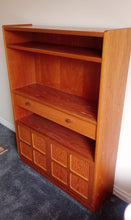 Load image into Gallery viewer, Discover the timeless elegance of this authentic Nathan dresser by Parker Knoll, a stunning piece from the 1970s crafted in warm teak wood. Featuring a single drawer and spacious double cupboard, this vintage dresser offers generous storage for your dining room, hallway, or living space. Structurally sound and well-maintained, it combines classic mid-century design with practical functionality. A genuine investment piece that brings character and warmth to any home.

Delivery Available

Overall Dimensions


