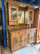 Load image into Gallery viewer, This beautifully crafted wooden dresser is sturdy and in excellent condition. While there may be a few minor blemishes, they do not significantly affect the overall quality. The top section features two cupboards and two drawers, while the lower section includes one double and one single cupboard, providing ample storage space. Additionally, this dresser can be disassembled into two pieces for easier transportation.

Overall Dimensions

approx : 149cm wide x 60cm deep x 211cm high

DELIVERY AVAILABLE      

