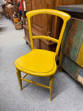 Load image into Gallery viewer, Bring warmth and character to your space with this vibrant mustard yellow wooden chair. Crafted with solid construction, this pre-loved piece combines durability with distinctive style. While it bears the gentle patina of its history, these subtle marks only enhance its authentic charm. Perfect for adding a cheerful splash of colour to bedrooms, living areas, or creative spaces, this chair promises both comfort and conversation-starting appeal.

Delivery Available

Overall Dimensions

approx : 40cm wide x 3
