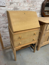 Load image into Gallery viewer, This teak bureau comes natural, displaying the wood in its untainted stripped state with visible grain and character. Storage is generous thanks to two substantial dovetail-jointed drawers, whilst a pull-down writing desk provides a dedicated work surface. The bare timber will need wax treatment for protection against daily use, giving you control over the final finish and ensuring longevity.

Delivery Available

Overall Dimensions

55.5cm wide x 41cm deep x 100cm high

