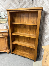 Load image into Gallery viewer, Discover the timeless appeal of this handsome oak bookcase, a piece originally from Oak Furniture Land. Built to last, this sturdy three-shelf unit offers generous storage space for your favourite books and treasures. While it has a few marks, it remains in excellent working condition—perfect for adding character and functionality to any room.

Overall Dimensions

98cm wide x 32cm deep x 150cm high

DELIVERY AVAILABLE      

For our other items see our website https://fossewayfurniture.co.uk

collection fro
