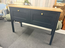 Load image into Gallery viewer, The Neptune sideboard combines durability with everyday practicality. Engineered for stability and currently in good working order, this piece shows only light wear that's barely noticeable. Two smooth soft-close drawers deliver dependable storage without fuss, whether you're furnishing a kitchen or living area. A no-nonsense option for those after honest, functional furniture that simply does the job well.

Delivery Available

Overall Dimensions

134cm wide x 52cm deep x 91cm high

