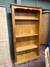 Load image into Gallery viewer, A charming pine bookcase with genuine character and practical appeal. Featuring a sturdy frame with one original pine shelf, complemented by two quality oak shelves that blend beautifully with the natural wood aesthetic. The piece shows its history through subtle surface patina but nothing that affects its use. Perfect for displaying books, treasures, and cherished items.&nbsp;

Delivery Available

Overall Dimensions

98.5cm wide x 35cm deep x 185cm high&nbsp; &nbsp; &nbsp;

