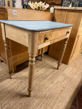 Load image into Gallery viewer, A charming vintage pine hall table with authentic character and patina. Structurally sound and in good condition, featuring a practical long drawer for storage. The grey-painted top shows its use with minor marks that add to its vintage appeal—a light refresh may enhance its appearance if desired. Perfect for hallways, home offices, or as a distinctive desk piece.

Delivery Available

Overall Dimensions

75cm wide x 45.5cm deep x 73cm high&nbsp;

