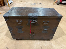 Load image into Gallery viewer, A beautifully crafted oriental hardwood trunk that combines practical storage with timeless appeal. The solid construction ensures durability, whilst the lift-up lid and internal drawers provide generous space for organising your belongings. Dual side handles make repositioning effortless. Minor surface marks reflect its character. An ideal piece for adding storage and distinctive style to any room.

Delivery Available

Overall Dimensions

87cm wide x 42cm deep x 66cm high&nbsp;&nbsp;
