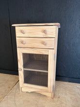 Load image into Gallery viewer, Stripped pine cupboard with rustic character. Features two spacious drawers and a single cupboard with internal shelf, offering practical storage for any room. The natural wood finish showcases the grain and patina of pine, though a protective wax coat is recommended to enhance durability. Structurally sound and in good condition, ready to become a cherished piece in your home.

Delivery Available

Overall Dimensions

53cm wide x 40cm deep x 92cm high

