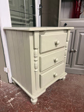 Load image into Gallery viewer, A compact sage green chest of drawers offering practical storage in a timeless colour. This pre-loved piece is structurally sound with three spacious drawers, perfect for bedrooms, hallways, or living spaces. Shows honest signs of use with minor surface marks that add to its character. An affordable way to introduce soft, natural tones to your home whilst choosing sustainably.

Delivery Available

Overall Dimensions

61cm wide x 44cm deep x 69.5cm high
