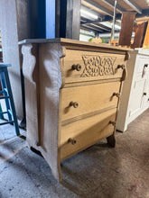 Load image into Gallery viewer, A beautiful mid-century oak chest of drawers, stripped to reveal its natural grain and warm patina. Features three spacious dovetail-jointed drawers, one of which has exquisite carved detailing on the top drawer. The bare wood finish offers authentic character and invites personalisation—consider a protective wax coat to enhance the timber and safeguard against daily wear. Ideal for bedrooms, hallways, or living spaces seeking vintage charm with practical storage.

Delivery Available

Overall Dimensions

68
