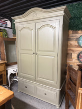 Load image into Gallery viewer, This stunning solid pine wardrobe features a rich 'Olivia' finish by Frenchic, complemented by a crisp white-washed interior. Woodland-print decoupage covers the drawer interiors, adding a nature-inspired touch. The piece offers generous storage with one hanging rail and two dovetail-jointed drawers. Designed for practicality, it disassembles into three sections for convenient transport and repositioning.

Delivery Available

Overall Dimensions

132cm wide x 61cm deep x 210.5cm high

