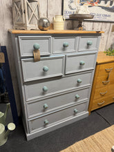 Load image into Gallery viewer, Solid pine chest of drawers with eight dovetail-jointed compartments across three short, two medium, and three long. The piece carries a grey paint layer from its previous owners and requires some practical work—several drawers need some attention to operate smoothly, whilst the entire surface would benefit from a repaint unless you like the distressed look this is perfect for buyers seeking an honest, workable piece with genuine pine construction and restoration potential.

Delivery Available

Overall Dime
