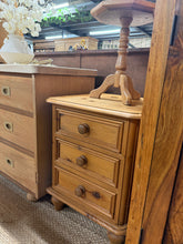 Load image into Gallery viewer, A charming vintage pine bedside table in sound structural condition, featuring authentic character marks that tell its story. Three dovetail-jointed drawers provide practical storage for bedside essentials. Perfect for adding warmth and craftsmanship to a bedroom scheme.

Delivery Available

Overall Dimensions

51cm wide x 50cm deep x 65cm high

