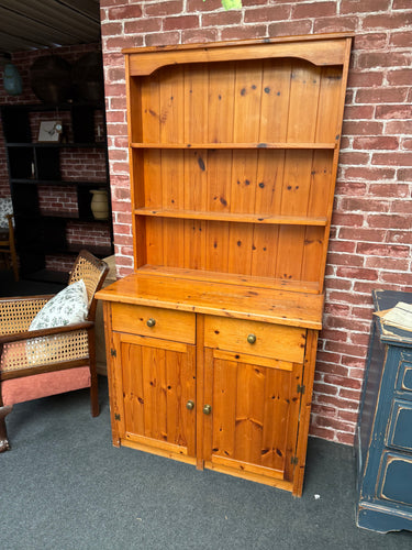This sturdy solid pine dresser is in good condition overall. It shows some signs of use with marks, but nothing that impacts its use. The top section features 2 shelves above 2 drawers, and the base includes a spacious double cupboard.

Delivery Available

Overall Dimensions

91cm wide x 43cm deep x 176cm high

