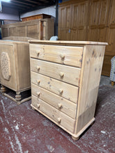 Load image into Gallery viewer, A beautiful stripped pine chest of drawers in its natural state, ready for finishing or displaying as-is. Featuring five spacious long drawers offering generous storage for bedrooms, living rooms, or hallways. The solid construction is structurally sound and in good condition. We recommend applying a protective coat of wax to enhance the wood's appearance and durability, though this versatile piece works equally well left natural for a rustic aesthetic.

Delivery Available

Overall Dimensions

80cm wide x 4
