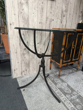 Load image into Gallery viewer, A timeless wrought iron side table with a practical glass top for effortless cleaning. The sturdy iron frame combines durability with classic elegance, making it a versatile addition to any room. Minor surface marks add to its authentic character. Perfect for displaying décor or holding essentials beside your sofa or armchair.

Delivery Available

Overall Dimensions

23.5cm diameter x 76cm high

