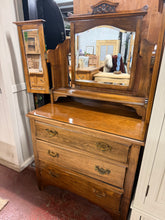 Load image into Gallery viewer, A solid beech dressing chest featuring three spacious dovetail-jointed drawers ideal for storing clothing and accessories. The piece shows its age with minor surface marks, but remains structurally robust and fully functional. The detachable mirror makes transportation and repositioning straightforward, adding practical versatility to this classic furniture piece.

Delivery Available

Overall Dimensions

91cm wide x 46cm deep x 85cm / 165cm high

