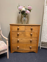 Load image into Gallery viewer, This charming oak chest of drawers combines practical storage with timeless appeal. Structurally sound and well-maintained, it features six generously proportioned drawers—four shorter dovetail-jointed drawers above two spacious long drawers—offering versatile organisation for any room. The natural patina and minor marks reflect its character and authentic vintage charm. Ideal for bedrooms, living spaces, or hallways seeking both function and classic style.

Delivery Available

Overall Dimensions

87cm wide
